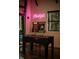 Fun game room featuring a foosball table and arcade games, illuminated by a neon 