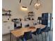 Stylish kitchen with modern appliances, a large wooden dining table, and open shelving at 665 Lonach Ln, Roxboro, NC 27574