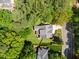 High angle aerial view of backyard with trees, grass, and a sidewalk nearby at 6819 Rainwater Rd, Raleigh, NC 27615