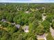 Scenic aerial view of a home surrounded by a dense forest, highlighting the privacy and natural beauty at 6819 Rainwater Rd, Raleigh, NC 27615