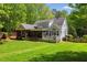 View of the two story home from the backyard featuring a screened in porch at 6819 Rainwater Rd, Raleigh, NC 27615
