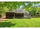 A spacious backyard with deck, screened in porch, and lush lawn at 6819 Rainwater Rd, Raleigh, NC 27615