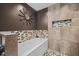 Charming bathroom features decorative tile accents, a bathtub, and a modern shower with dual shower heads at 6819 Rainwater Rd, Raleigh, NC 27615