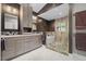 Modern bathroom with dual sinks, custom cabinetry, and glass-enclosed shower at 6819 Rainwater Rd, Raleigh, NC 27615