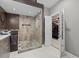 Elegant bathroom with a walk-in shower featuring a mosaic tile floor and a conveniently located walk-in closet at 6819 Rainwater Rd, Raleigh, NC 27615