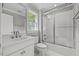 Bright bathroom with a walk-in shower, window, and white vanity at 6819 Rainwater Rd, Raleigh, NC 27615