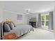 Bright bedroom with large window, ceiling fan, and comfortable king-sized bed at 6819 Rainwater Rd, Raleigh, NC 27615
