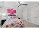 Bedroom with a ceiling fan, decorative accents, and cozy floral bedding, creating a peaceful retreat at 6819 Rainwater Rd, Raleigh, NC 27615