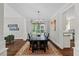 Elegant dining room with a large table, chandelier, and natural light from a large window at 6819 Rainwater Rd, Raleigh, NC 27615