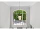 Light-filled two story foyer with a large window and an elegant hanging pendant lamp at 6819 Rainwater Rd, Raleigh, NC 27615
