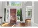Bright foyer featuring a wood door, hardwood floors, and lots of natural light at 6819 Rainwater Rd, Raleigh, NC 27615