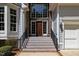 A close-up of home's front entrance featuring a stone facade and wood door at 6819 Rainwater Rd, Raleigh, NC 27615
