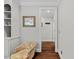Hallway featuring hardwood floors, built-in shelving, and neutral wall color at 6819 Rainwater Rd, Raleigh, NC 27615
