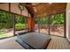 Screened porch featuring a hot tub, wood ceiling, and view of the backyard at 6819 Rainwater Rd, Raleigh, NC 27615