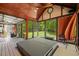Hot tub with ceiling fan and hammock in enclosed porch overlooking backyard at 6819 Rainwater Rd, Raleigh, NC 27615
