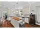 Bright kitchen with an island, stainless steel appliances, and open access to dining area at 6819 Rainwater Rd, Raleigh, NC 27615
