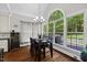 Kitchen open to dining area with bright natural light, wine fridge and modern appliances at 6819 Rainwater Rd, Raleigh, NC 27615