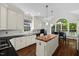 Bright kitchen featuring white cabinetry, stainless steel appliances, and a butcher block island at 6819 Rainwater Rd, Raleigh, NC 27615