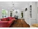 Bright living room featuring hardwood floors, stylish lighting, and access to outdoor area at 6819 Rainwater Rd, Raleigh, NC 27615