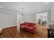 Open living room area featuring hardwood floors and seamless access to adjacent dining at 6819 Rainwater Rd, Raleigh, NC 27615