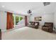 Bright living room with a large window, comfortable seating, and a window view at 6819 Rainwater Rd, Raleigh, NC 27615