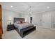 Comfortable main bedroom with plush carpet, designer headboard, and overhead lighting at 6819 Rainwater Rd, Raleigh, NC 27615