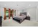 Spacious main bedroom with large windows, plush carpet, and tray ceiling at 6819 Rainwater Rd, Raleigh, NC 27615