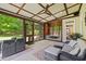 Covered porch featuring comfortable wicker seating and views of the backyard at 6819 Rainwater Rd, Raleigh, NC 27615