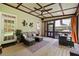 Enclosed porch with wicker seating, rug, plants, and beautiful backyard views at 6819 Rainwater Rd, Raleigh, NC 27615