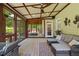 Comfortable screened porch with ceiling fan, wicker seating and hot tub access at 6819 Rainwater Rd, Raleigh, NC 27615