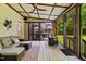Well-furnished screened porch with grill access and serene backyard views at 6819 Rainwater Rd, Raleigh, NC 27615