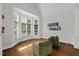 A sitting area featuring hardwood floors, a bay window, and two chairs at 6819 Rainwater Rd, Raleigh, NC 27615