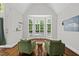 A sitting area featuring hardwood floors, a bay window, and two chairs at 6819 Rainwater Rd, Raleigh, NC 27615