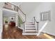 Bright foyer with hardwood floors, staircase, and elegant mirror create a welcoming entry at 6819 Rainwater Rd, Raleigh, NC 27615