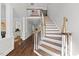 View of entry staircase and hardwood floors leading into the main level of the home at 6819 Rainwater Rd, Raleigh, NC 27615