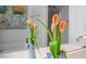 Close-up on fresh tulips adding a pop of color to the modern bathroom vanity at 708 Copperline Dr # 101, Chapel Hill, NC 27516