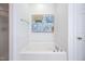 Clean white bathtub with tiled surround and shower, ideal for relaxation at 708 Copperline Dr # 101, Chapel Hill, NC 27516