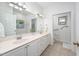 Bright bathroom featuring a double vanity, a decorative mirror, and a separate toilet area at 708 Copperline Dr # 101, Chapel Hill, NC 27516