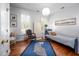 Cozy bedroom with hardwood floors, bright windows, and a vibrant blue leopard-print rug at 708 Copperline Dr # 101, Chapel Hill, NC 27516