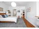 Spacious bedroom with hardwood floors, neutral walls, and a view into the living room at 708 Copperline Dr # 101, Chapel Hill, NC 27516