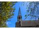 Historic stone church featuring a tall, elegant spire against a clear blue sky, framed by trees at 708 Copperline Dr # 101, Chapel Hill, NC 27516