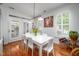 Dining room with bright hardwood floors, white table, and shutters at 708 Copperline Dr # 101, Chapel Hill, NC 27516
