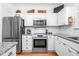Modern kitchen with granite countertops, stainless appliances, and white cabinets at 708 Copperline Dr # 101, Chapel Hill, NC 27516