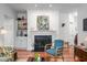 Cozy living room with a fireplace, built-in shelves, hardwood floors and stylish accents at 708 Copperline Dr # 101, Chapel Hill, NC 27516