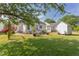 Expansive backyard showcasing a dining area, seating, shed, and landscaping, creating the perfect outdoor living space at 715 Barlang Cir, Fuquay Varina, NC 27526