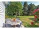 Backyard featuring patio area, round table with chairs, and garden at 715 Barlang Cir, Fuquay Varina, NC 27526