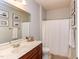 Clean bathroom features a single vanity, framed mirror, and shower with tub combo at 715 Barlang Cir, Fuquay Varina, NC 27526