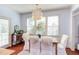 Sunlit dining area features a table with seating, a buffet, and large windows overlooking the backyard at 715 Barlang Cir, Fuquay Varina, NC 27526