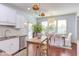 Well-lit eat-in kitchen with stainless appliances, stone counters, and a dining area with outdoor access at 715 Barlang Cir, Fuquay Varina, NC 27526