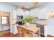 Bright eat-in kitchen with stainless steel appliances, stone countertops, and modern light fixtures at 715 Barlang Cir, Fuquay Varina, NC 27526